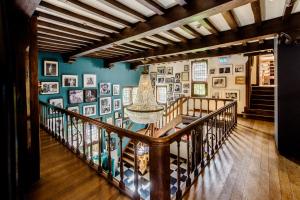 a staircase in a room with pictures on the walls at Boutique Hotel Villa Beukenhof - Leiden in Oegstgeest