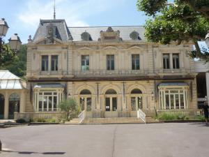 an old building with a staircase in front of it at La villa des fleurs in Lamalou-les-Bains