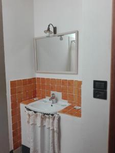 a bathroom with a sink and a mirror at Torre Di Ponzano in Barberino di Val dʼElsa