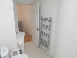 a small bathroom with a toilet and a sink at 4 bed comfy house, cork, suit 7 guest max in Cork