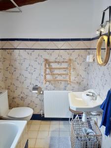 a bathroom with a white toilet and a sink at Casas Benali in Benali