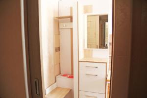 a bathroom with a white cabinet and a mirror at Apartment in the city center in Ivano-Frankivsʼk +37 photos