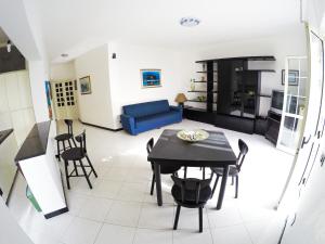 - un salon avec une table et un canapé bleu dans l'établissement Appartamento Fronte Spiaggia con Terrazza Vista Mare, à Bonifati