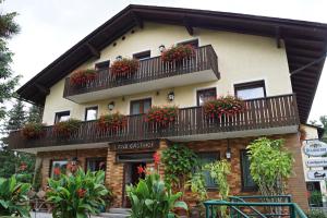 a building with flower boxes on the balconies at Hotel-Landgasthof Henghuber in Rötz