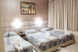 Postel nebo postele na pokoji v ubytování Hotel Real