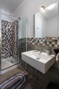 a bathroom with a white sink and a shower at Il vecchio e il mare in San Vito lo Capo