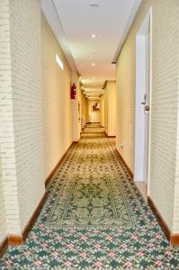 a hallway of a hotel with a rug on the floor at Hotel 6 de Octubre in Buenos Aires