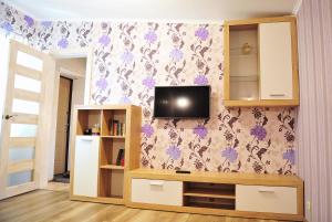 a living room with a tv on a wall at Apartment Sea Breeze in Fontanka