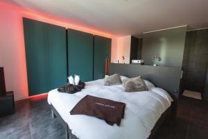 a bedroom with a large bed with two towels on it at Loft Aan Het Water in Grobbendonk