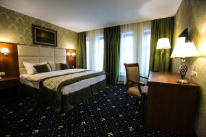 a hotel room with a bed and a desk at Sobranie hotel in Volgograd