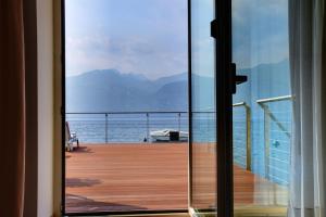 a view of the ocean from a balcony of a cruise ship at Hotel Vega in Malcesine