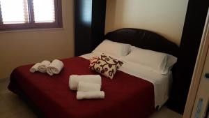 a bedroom with a bed with towels on it at La Suite in SantʼAlessio Siculo