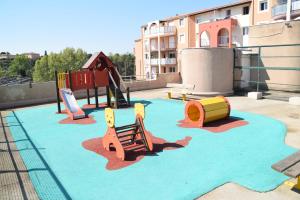 a playground with colorful play equipment on a roof at le lagon bleu - Fréjus in Fréjus