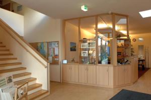 a room with a staircase and a glass cabinet at A&S Ferienzentrum Schwerin in Schwerin