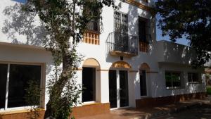 a white building with two balconies on it at Mansion IBIZA Salou in Reus