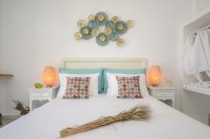 a bedroom with a white bed with two lamps at Naxos Dream Oniro Studios - Adults Only in Naxos Chora