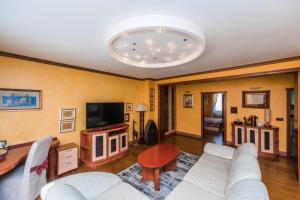 a living room with a white couch and a tv at Apartment Keti in Novalja