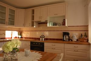 a kitchen with white cabinets and a wooden table at Pr' Koritnek in Bled +7 photos