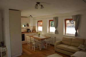 a kitchen and living room with a table and a couch at Pr' Koritnek in Bled