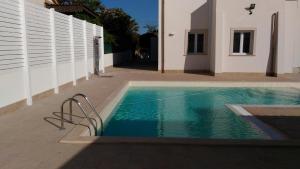 a swimming pool in front of a white building at Archiammare Sea in San Lorenzo