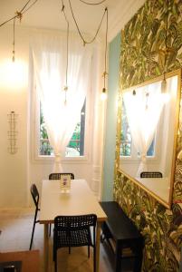 a dining room with a table and chairs and a mirror at Arty 20m² district of BATIGNOLLES in Paris