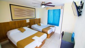 Postel nebo postele na pokoji v ubytování Hotel Tepic + 10 fotografií