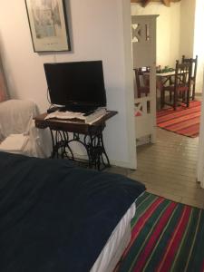 a computer monitor sitting on a table in a room at Aparts del Jardin in Tigre