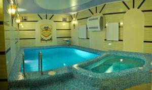 a large swimming pool in a room with at Sherwood Hotel in Dovgomostys”ka