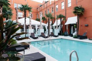 a hotel room with a pool and a balcony at Mansion on Forsyth Park in Savannah