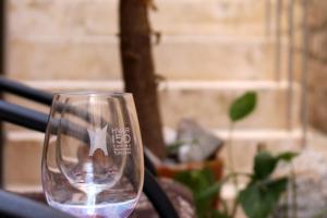 a wine glass sitting on top of a table at Street Garden Apartment in Hvar