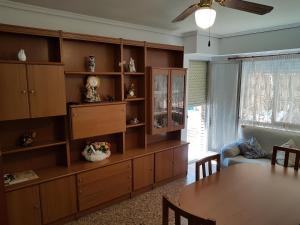 a living room with a table and a large book shelf at playa y relax valencia in Puerto de Sagunto
