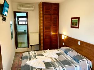 Säng eller sängar i ett rum på Pousada Icaraí