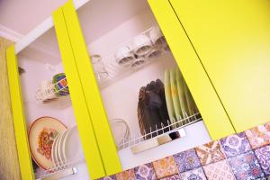 a yellow cabinet filled with dishes and plates at Apartment Sea Breeze in Fontanka +32 photos