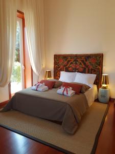 a bedroom with a large bed with two pillows on it at Alto Belo in Felgueiras +39 photos