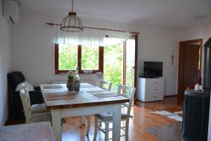a kitchen and dining room with a table and chairs at Grandma's House in Bled