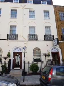 
a white building with two windows and a blue door at Central Hotel in London
