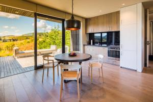 a kitchen and dining room with a table and chairs at Kinloch Manor & Villas in Kinloch