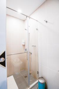 a shower stall in a bathroom with a toilet at Palau Hotel in Koror