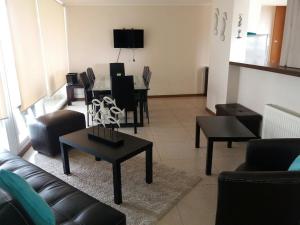 a living room with a couch and a table and chairs at Departamento en La Serena in La Serena