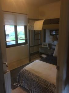 a bedroom with two bunk beds and a window at Pucon casa condominio Alicura in Pucón