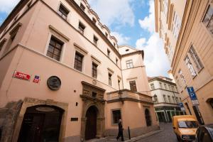 a building on a street with a person standing in front of it at Kozna Loft in Prague