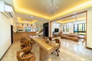 a dining room and living room with a wooden table and chairs at Zhitian Heye in Chenggong