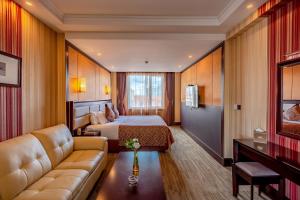 a hotel room with a bed and a couch at Grand Hill Hotel Ulaanbaatar in Ulaanbaatar +32 photos