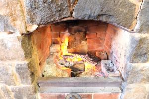 a brick oven with a fire in it at The Caledonian Inn in Port Fairy