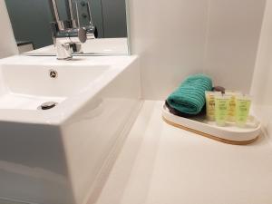 a bathroom sink with a towel on top of it at William Macintosh Motor Lodge in Naracoorte