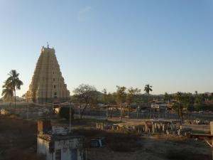 a view of a temple with a tower in the background at Padmaa Hampi Villa in Hampi