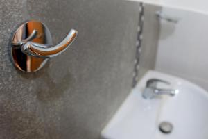 a bathroom with a white sink and a toilet at En el centro y hermosa vista! Con cochera in Trujillo +29 photos