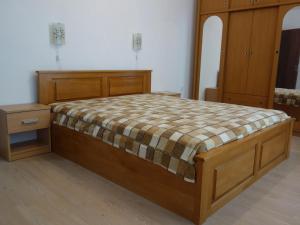 a bedroom with a wooden bed and a wooden cabinet at Sea Garden Marina 2 in Varna City +24 photos