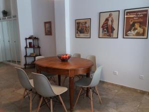 a dining room with a wooden table and chairs at Feels like home with luxury details in Athens