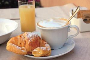 a cup of coffee and a pastry on a table at La Collina di nonno Carmine in Santa Paolina